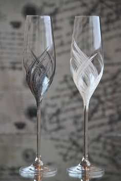 two wine glasses sitting next to each other on a table