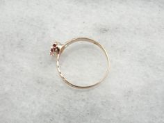 Small and set low to the hand, this pretty antique ring is easy to wear! This would have been worn as an engagement ring, a birthstone ring or a ladies every day ring! We have set this pretty old mounting with a stunning ruby weighing nearly half a carat. Metal: 10K Rose Gold Gem: Ruby .53 Carat Gem Measurements: 4.1 x 5.5 mm, Oval Ring Size: 7.75 Marks: "[x]10K" Stamped on the inside band Antique 14k Gold Solitaire Ring, Antique 14k Gold Round Flower Ring, Antique 14k Gold Birthstone Ring For Promise, Antique 14k Gold Birthstone Promise Ring, Antique Round Flower Ring In 14k Gold, 14k Gold Solitaire Flower Ring, 14k Gold Antique Birthstone Ring For Promise, Heirloom Birthstone Promise Ring With Round Stone, Antique 14k Gold Ruby Ring With Birthstone