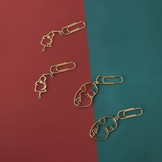 three different types of paper clips sitting next to each other on a red and blue background