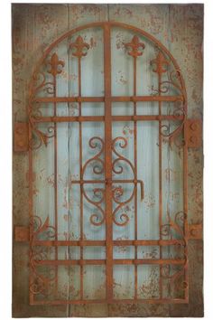 an old iron gate with decorative designs on it