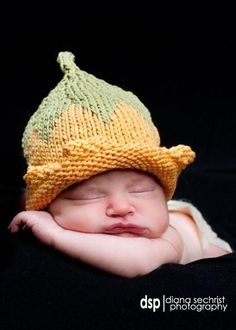 a newborn baby wearing a knitted hat