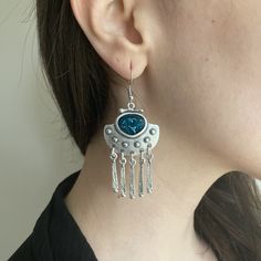 Elevate your style with our Ethnic Silver Dangle Drop Earrings with Blue Enamel, handmade from silver-plated Zamac. Perfect for everyday Boho flair and a thoughtful gift for your girlfriend. Discover comfort in Bohemian design. The unique dangle drop style adds a touch of individuality, making them a versatile choice for any occasion. The silver-plated Zamac not only ensures durability but also brings a subtle gleam to enhance your overall look. Zamac, composed of zinc, aluminum, magnesium, and Blue Metal Earrings With Latkans, Bohemian Blue Metal Earrings, Blue Bohemian Metal Earrings, Bohemian Blue Danglers, Blue Metal Earrings For Festivals, Bohemian Blue Metal Chandelier Earrings, Blue Metal Bohemian Chandelier Earrings, Festival Jewelry, Bohemian Design