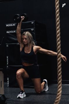 a woman doing squats with a rope in front of her