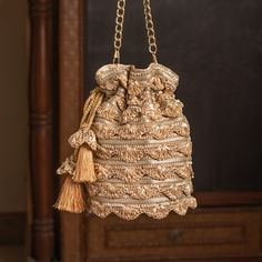 Contemporary Gota Lace Embellished Luxurious Bridal Party Pouch with Sling Chain | Stylish Round-Shaped Fashion Accessory Drawstring Purse Package Contents: 1 Size: 10" x 8" Designed with the heart, this beautiful Potli or batawa bag are eye catchy and made of premium material. Key Features: This potli is good match with both Indian and western outfits and are superb for wedding and festive parties. This would be best complement to your designer saree, lenhga or any other kind of dress. This is the combination of traditional and modern embroidery work. This is enough to keep your accessories and all needed essentials and it can be a best gift for any woman. Festive Tasseled Potli Bag For Reception, Festive Potli Bag With Tassels For Reception, Festive Reception Potli Bag With Tassels, Traditional Tassel Potli Bag For Reception, Elegant Potli Bag With Tassels For Reception, Gold Potli Bag With Latkans For Reception, Traditional Bags With Tassels For Reception, Traditional Tassel Bags For Reception, Traditional Evening Potli Bag With Latkans