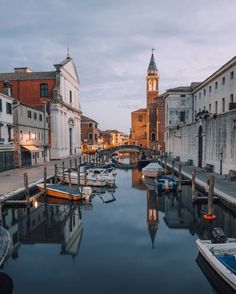 boats are docked in the water next to buildings