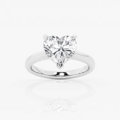 a heart shaped diamond ring on a white background