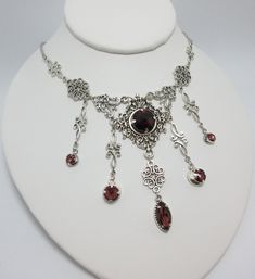 "This is a new handmade necklace. It is made with antiqued silver plated filigrees, accented with high quality AMETHYST PURPLE glass jewels/rhinestones that sparkle like crystals. Decorated portion is 6 1/2\" wide and 3 1/4\" tall in the center. Necklace is adjustable 15-18\" with a lobster clasp and chain extender. If you would like a different length, please send us a message. Matching earrings and headpiece are listed in our store." Silver Necklaces With Historical Design For Wedding, Medieval Engraved Jewelry For Weddings, Medieval Engraved Wedding Jewelry, Medieval Style Engraved Wedding Jewelry, Gothic Metal Jewelry With Filigree, Gothic Filigree Metal Jewelry, Gothic Sterling Silver Jewelry With Intricate Design, Antique Silver Necklace With Historical Design, Ornate Decorative Necklaces For Wedding