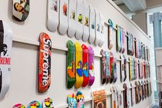 there are many skateboards hanging on the wall