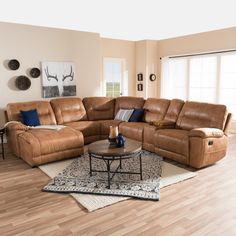 a living room filled with lots of furniture and decor on top of a hard wood floor