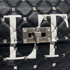 Pre-owned Valentino Bag Black Leather Printed VLTN Rock stud accents Pale Gold-Tone Hardware Flat Handle & Removable Chain-Link Strap Red/Black Leather Lining & Dual Interior Pockets Turn-Lock Closure at Front Guaranteed authentic. Condition: 8.5/10 Very good. Light signs of use to interior. Indentations to inside flap from hardware. Scratches to the white Letter “T” Details: Shoulder Strap Length: 22.25" Handle Drop: 3" Height: 6.5" Width: 9.75" Depth: 3 Luxury Shoulder Bag With Rivets, Designer Black Bag With Studs, Designer Black Bags With Studs, Designer Black Studded Bag, Luxury Black Bags With Rivets, Black Designer Bag With Rivets, Valentino Bag Black, Valentino Bag, Valentino Bags