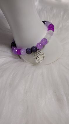 Amethyst Allure Bracelet  with Gemstone Crystal Beads, and Glass Beads, and Silver Charm. Each Charm is Random for Each Bracelet. Adjustable Purple Gemstone Beads Crystal Bracelet, Adjustable Purple Crystal Bracelet With Gemstone Beads, Adjustable Amethyst Beads For Jewelry Making, Purple Gemstone Beads For Gift, Purple 8mm Beads Bracelet, Purple Beaded Rosary Bracelet, Purple 8mm Bead Bracelet, Purple Crystal Bracelet With Faceted Beads For Healing, Adjustable Purple Round Beads Charm Bracelet