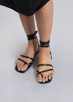 Color: Black Soft leather sandal Wrap around ankle strap Front toe detailing Padded insole Low platform 100% Leather Upper Leather Outsole By Mari Giudicelli. Made in Brazil Leather Lace-up Sandals With Ankle Strap, Black Lace-up Sandals With Adjustable Strap, Black Lace-up Sandals With Adjustable Strap For Spring, Black Ankle Strap Wedge Sandals, Black Wedge Sandals With Ankle Strap, Leather Sole Lace-up Open Toe Sandals, Black Slingback Sandals With Open Heel, Black Slingback Sandals With Strap And Open Heel, Black Open Heel Slingback Sandals With Strap