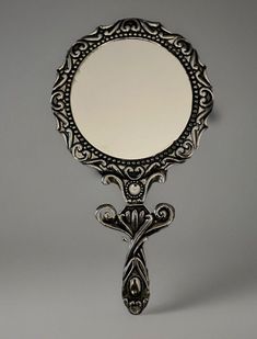 an ornate mirror is hanging on the wall