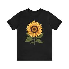 a black t - shirt with a yellow sunflower on the front and green leaves