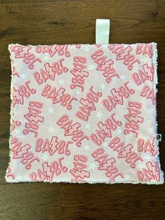 a pink and white fabric with the words happy birthday on it