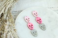 "These are such fun and festive acrylic earring pieces made with 3 Halloween skull charms. You get a light pink Skull, a metallic hot pink skull and a holographic silver Skull Charm. You get enough pieces to make three pairs of acrylic earrings (NO HARDWARE IS INCLUDED) These measure just about 2\" long.  NO Hardware is included! You will receive enough pieces to make 3 total pairs, 6 witch hats, 6 pumpkins, and 6 white ghosts" Pink Dangle Jewelry For Halloween, Pink Skull Jewelry For Halloween, Pink Halloween Party Earrings, Skull Earring, Earring Stack, Pink Holographic, Laser Projects, Acrylic Blanks, Witch Hats