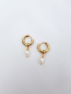 Mini hoop earrings with small pearl charm! These dainty freshwater baroque pearl earrings are perfect addition to you jewelry collection. Mixing all time favorite - hoops and all time classic -pearls, makes these earrings both- beautiful and timeless! It's definitely a must have! You also can take off pearl charms and have plain hoops earrings when needed! Check other pearl earrings here - https://www.etsy.com/shop/GinandJewelryShop?section_id=32608833 Message me if you need larger quantity than Everyday Pearl Drop Dangle Hoop Earrings, Everyday Hoop Earrings With Pearl Charm, Delicate Dangle Hoop Earrings With Pearl Charm, Gift 14k Gold Hoop Earrings With Pearl Chain, Everyday Pearl Charm Dangle Huggie Earrings, Everyday Dangle Pearl Earrings With Pearl Charm, Dainty Pearl Chain Hoop Earrings As Gift, Dainty Pearl Charm Drop Earrings, White Gold Plated Hoop Pearl Earrings