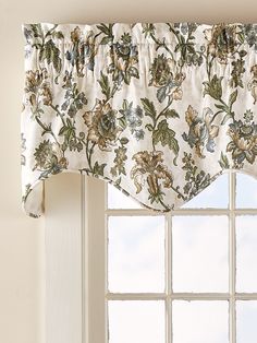 a window with a flowered valance hanging from it's side