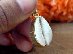 Handmade Cowrie Shell bohemian pendant Title -Cowrie Shell pendant Stone color - White Material - Sterling silver 925 we are giving you best quality rings on best price .. contact us for more quantity Bohemian Brass Jewelry For Beach, Bohemian Brass Jewelry For The Beach, Handmade Traditional Jewelry As Gift For Her, Traditional Handmade Jewelry For Her, Traditional Handmade Jewelry As Gift For Her, Handmade Round Pendant Jewelry For Beach, Bohemian Oval Pendant For Jewelry Making, Artisan Gold Beach Jewelry, White Bohemian Necklace With Charms