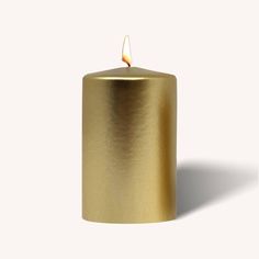 a gold colored candle with a white background