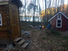 there are two small cabins in the woods next to each other and one has a door open