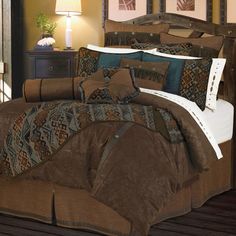 a bed in a room with brown and blue comforters