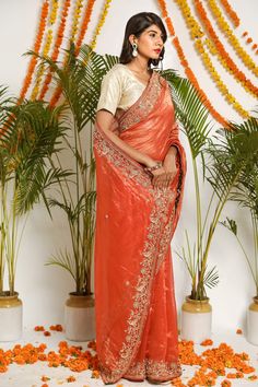 Dark orange pure tissue saree with intricate zardozi and sequins hand embroidered in floral motifs. Paired with blouse.
Component: 2
Pattern: Embroidered
Type Of Work: Floral
Sleeve Type: Short Sleeves
Fabric: Pure Tissue
Color: Orange
Other Details: 
Zardozi and sequin work
Floral motifs
Occasion: Wedding - Aza Fashions Navratri Gota Work Pre-draped Saree In Tissue Silk, Orange Pre-draped Saree For Diwali, Orange Pre-draped Saree With Zari Work, Traditional Orange Art Silk Pre-draped Saree, Bollywood Style Orange Chinon Dupatta, Orange Bollywood Style Chinon Dupatta, Bollywood Orange Chinon Dupatta, Orange Chinon Bollywood Dupatta, Festive Orange Art Silk Pre-draped Saree