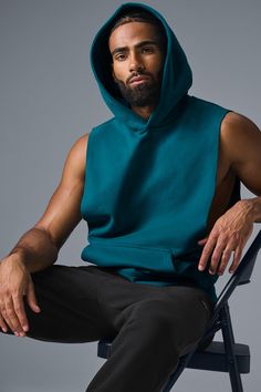 Stay cozy without sacrificing style in the Renown Sleeveless Hoodie. It has deep armholes, a kangaroo pocket, and a laid-back cut. And wait till you feel the Alo signature Renown fabric—it's smooth on the outside, a little fleecy on the side, and heavyweight for a just-right drape. Add shorts and you’re covered from the gym to the street. Athleisure Tops With Kangaroo Pocket For Streetwear, Sleeveless Cotton Hoodie For Loungewear, Hooded Top With Side Pockets For Streetwear, Alo Yoga Hooded Top With Drawstring Hood, Athleisure Hoodie Top With Pockets, Stretch Hoodie Top With Pockets, Sleeveless Hoodie With Drawstring Hood For Fall, Sporty Sleeveless Alo Yoga Tank Top, Alo Yoga Sporty Sleeveless Tank Top