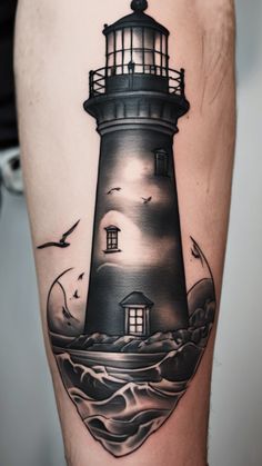 a man's leg with a lighthouse tattoo on it