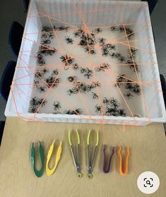 a box filled with lots of different colored toothbrushes on top of a table