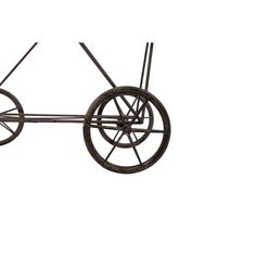 an old fashioned metal cart with wheels on it's sides and four spokes