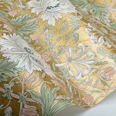 a close up view of a yellow and green wallpaper with white flowers on it