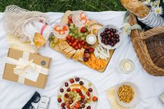 an assortment of food on a picnic blanket