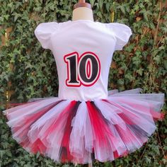 This Stranger Things Custom Outfit features a cotton shirt with a Stranger Things Hellfire Club theme in red, black, and white. Perfect for a unique and memorable birthday look, or for showing your appreciation of the show. Red Fitted T-shirt For Party, White Cotton Tops For Fan Events, Red Fitted Tops For Cheerleading, Fitted Red Tops For Cheerleading, Red Cotton Party T-shirt, Fitted White T-shirt For Cheerleading, Red Cotton T-shirt For Cheerleading, White Fitted T-shirt For Birthday, Red Fitted Top For Birthday