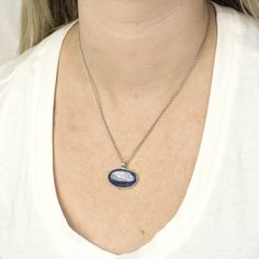 A rich blue stone with natural color banding and depth, this blue beauty will compliment any look. Kyanite is one of the few minerals that never need cleansing or clearing, as it does not retain any negative energy or vibrations. Wearing this gemstone aligns all chakras, bringing you tranquility and a calming effect to one's whole being. It is the perfect stone to facilitate meditation. Stone Origin: BrazilPlease Note: All pieces shipped within 48 hours from our Del Mar Gallery Measures Approxim Polished Finish Oval Necklace For Memorial, Oval Necklace With Polished Finish For Memorial, Oval Necklace With Polished Finish For Memorials, Sterling Silver Necklace With Large Oval Stone, Oval Sterling Silver Necklace With Large Stone, Spiritual Oval Necklace With Polished Finish, Silver Necklace With Large Oval Cabochon Stone, Spiritual Oval Cabochon Necklace, Sterling Silver Oval Pendant Necklace With Cabochon