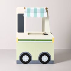 an ice cream cart with a striped awning