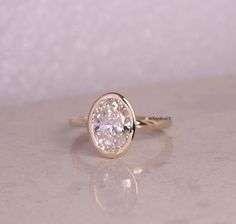 a gold ring with a white diamond on it