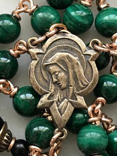 This rosary is handmade with 20 gauge bronze wire and chain, and bronze rosary medals. The stones are 6mm malachite gemstones and 8mm onyx gemstones. Bronze Rosary With Round Beads As Gift, Handmade Bronze Spiritual Rosary, Handmade Spiritual Bronze Rosary, Handmade Bronze Rosary As A Gift, Bronze Rosary As Gift, Holy Spirit Dove, Custom Rosary, Jesus Face, Rosary Bracelet