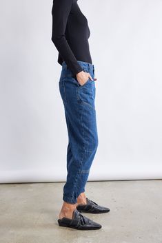 A new kind of denim pant: these relaxed fit pants are so comfortable they feel like loungewear. Made with a unique light denim fabric to fit in seamlessly with the rest of your wardrobe. Designed to have a jogger-style silhouette but look and feel like soft denim. Jogger style light denim fabric Elastic ankle cuff Elastic back waistband 2 back pockets, 2 side pockets Belt loops Button and zip front closure Relaxed Blue Denim Bottoms, Casual Indigo Cropped Leg Bottoms, Casual Indigo Cropped Bottoms, Relaxed Medium Wash Jeans With Pockets, Casual Indigo Tapered Leg Pants, Casual Tapered Leg Medium Wash Bottoms, Casual Blue Cropped Tapered Jeans, Casual Blue Tapered Leg Cropped Jeans, Blue Tapered Leg Cropped Jeans