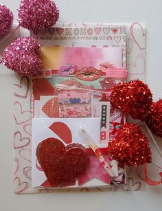 valentine's day scrapbook spread with pink and red glitter hearts, cupcake toppers, paper heart decorations