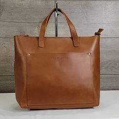 Used In Excellent Condition, Has No Sign Of Wear Smoke Free Home Measures: 13"W X 10"H X 4.5"D Message Me With Any Questions Thank You. Business Crossbody Bag With Leather Handles, Chic Leather Laptop Bag For Shopping, Chic Leather Laptop Bag For On-the-go, Cognac Bags For On-the-go, Leather Box Bag With Detachable Strap For Shopping, Leather Bag With Detachable Handle For Everyday, Cognac Leather Handheld Bag, Handheld Leather Bag In Cognac Color, Leather Top Handle Shoulder Bag For On-the-go