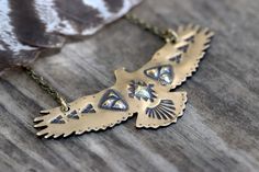 "This listing is for one hand stamped brass hawk necklace. Wear this bohemian necklace to show your affinity and love for all things natural, spiritual, and sky-bound. It is a powerful and eye-catching piece. - Hawk is made from 18 gauge brass sheet metal. This is a sturdy piece- it is not flimsy. - Pendant measures 3\" by 1 1/4\" (75mm by 30mm) - Chain in photo measures 16\" from end to end, but can be lengthened to your preference. Choose at check-out! Also, I can suspend it on black or brown Spiritual Etched Brass Necklace, Bohemian Hand Stamped Necklace Gift, Bohemian Hand Stamped Necklace For Gift, Artisan Stamped Brass Jewelry, Artisan Brass Necklaces With Etched Details, Handmade Southwestern Gold Necklace, Bohemian Engraved Brass Necklaces, Bohemian Brass Jewelry With Engraving, Bohemian Brass Necklace With Etched Details