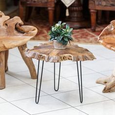 a wooden table topped with a potted plant on top of metal hairpin legs