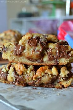 three cookies stacked on top of each other with chocolate chips and walnuts in the middle