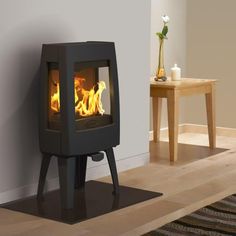 a wood burning stove sitting on top of a hard wood floor