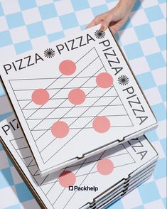 two pizza boxes are stacked on top of each other with the same pattern as people's hands