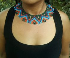 Embera necklace made by a woman from the Embera tribe in colombia Artisan Festival Choker Necklace, Handwoven Turquoise Jewelry For Festival, Fair Trade Unique Beaded Necklaces, Traditional Turquoise Choker Necklace, Handwoven Beaded Necklace For Festival, Traditional Handwoven Choker Jewelry, Traditional Turquoise Handwoven Jewelry, Unique Green Fair Trade Necklace, Handwoven Bohemian Choker Necklace