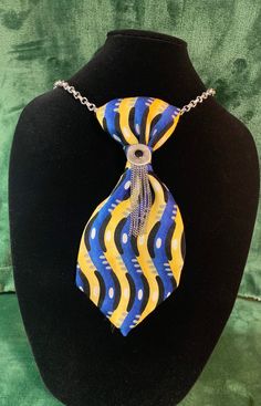 "Necktie on 30\" silver chain. Royal blue, yellow, black tie with pewter & black embellishments. Beautifully packaged." Adjustable Multicolor Necklace For Formal Occasions, Black Jewelry With Ties For Gifts, Black Ties Jewelry For Gift, Gift Black Jewelry With Ties, Upcycling Ties, Ties Crafts, Diy Necktie Projects, Mens Ties Crafts, Womens Ties