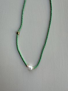 Necklace is made from green miyuki beads and pearl. Its different colors are also available. Green Round Bead Necklaces For The Beach, Green Tiny Beads Necklace For Beach, Green Beach Necklace With Colorful Beads, Green Polished Beaded Necklace For Festival, Green Pearl Necklace With Polished Round Beads, Green Polished Beads Necklace For Festivals, Green Tiny Heishi Beads Necklaces, Green Heishi Bead Round Necklaces, Green Necklaces With Spacer Beads For Festivals