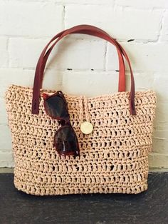 a straw bag with sunglasses on it